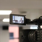 A video camera screen showing Ecology CEO Gareth Griffiths speaking.