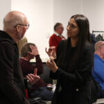 A man and a woman speaking enthusiastically.